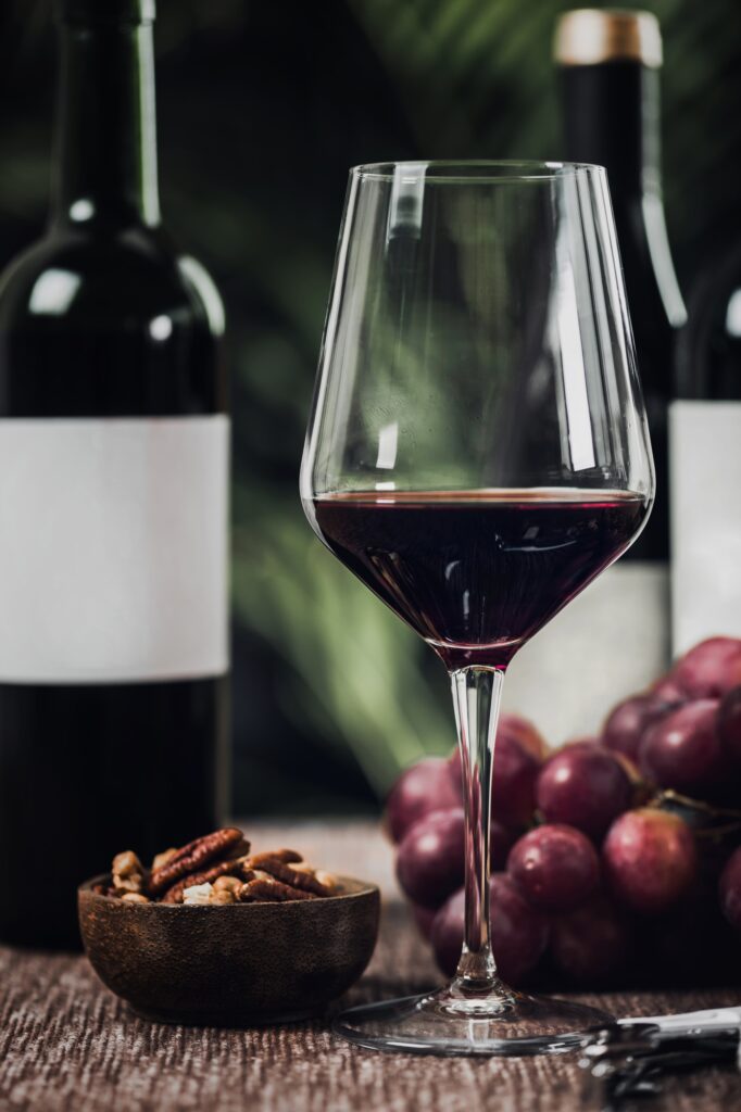 Bottles Of Red Wine, Wine Glasses And Grapes
